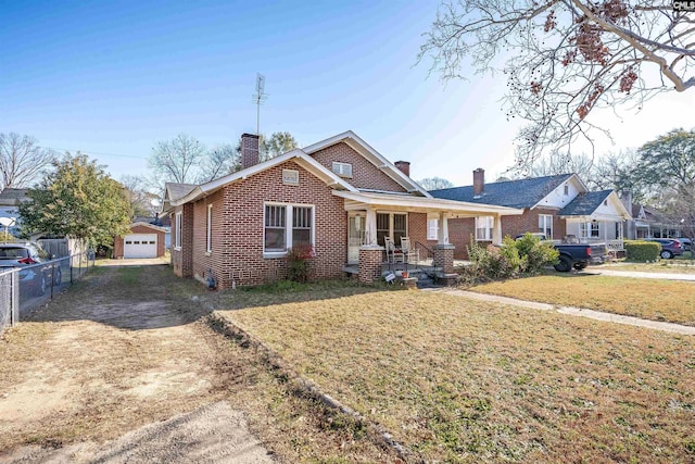 view of front of property with an outbuilding, brick siding, a chimney, dirt driveway, and fence