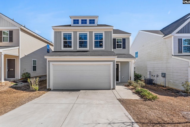 view of front of property featuring board and batten siding, cooling unit, driveway, and an attached garage