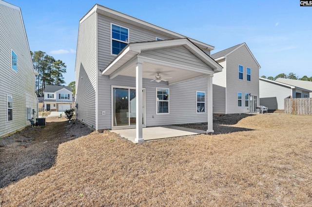 rear view of property with fence, ceiling fan, a lawn, and a patio