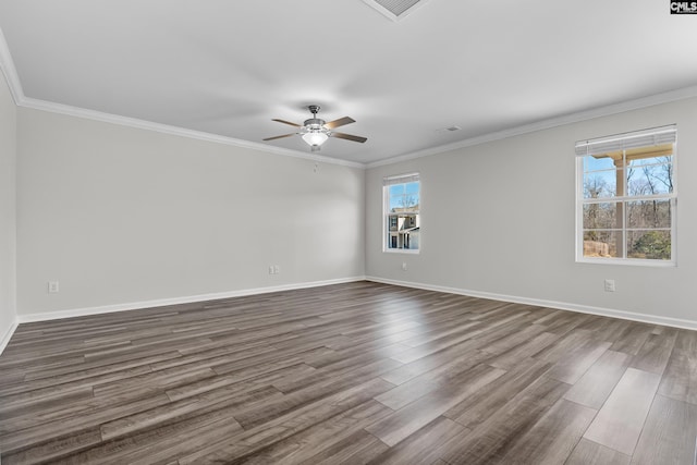 empty room featuring ornamental molding and dark wood-style flooring