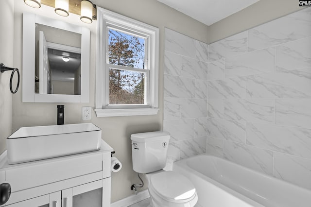 bathroom featuring baseboards, vanity, toilet, and tub / shower combination