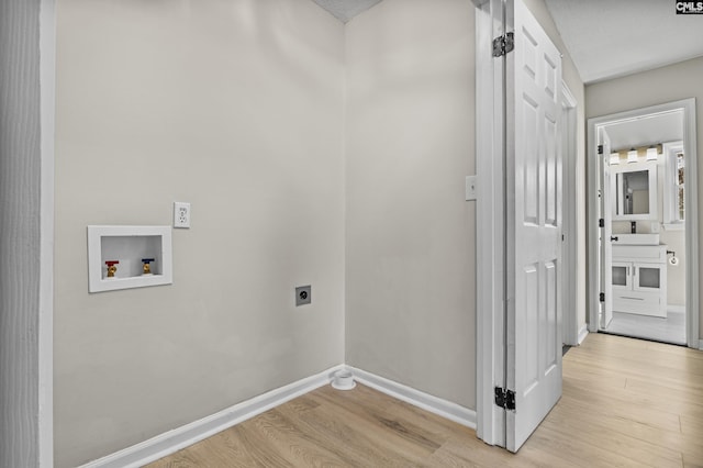 washroom featuring hookup for a washing machine, laundry area, light wood-style flooring, and electric dryer hookup