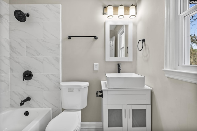 bathroom with vanity, bathtub / shower combination, and toilet