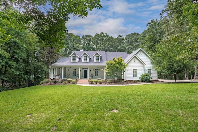 cape cod home with a porch, a chimney, and a front lawn