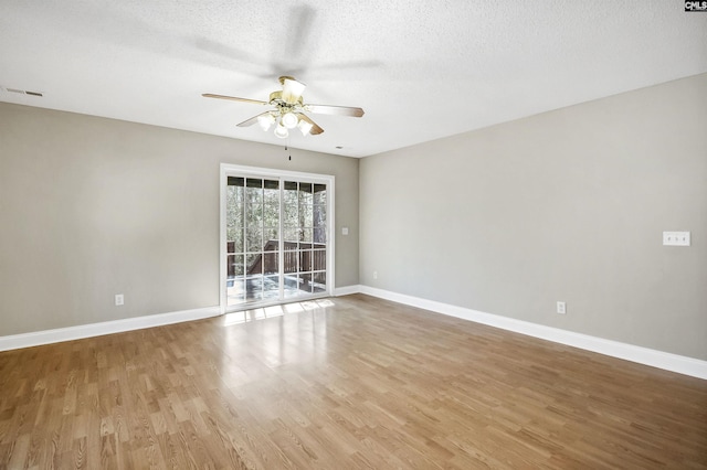 spare room with baseboards, visible vents, and light wood finished floors