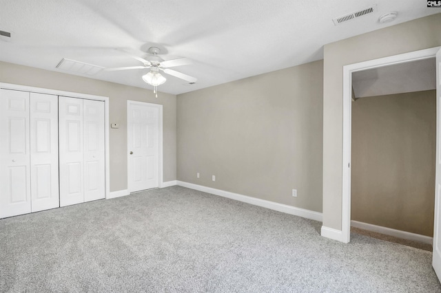 unfurnished bedroom with a closet, baseboards, visible vents, and carpet flooring