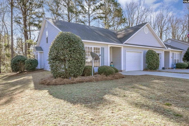 view of front of house featuring a garage, driveway, and a front lawn