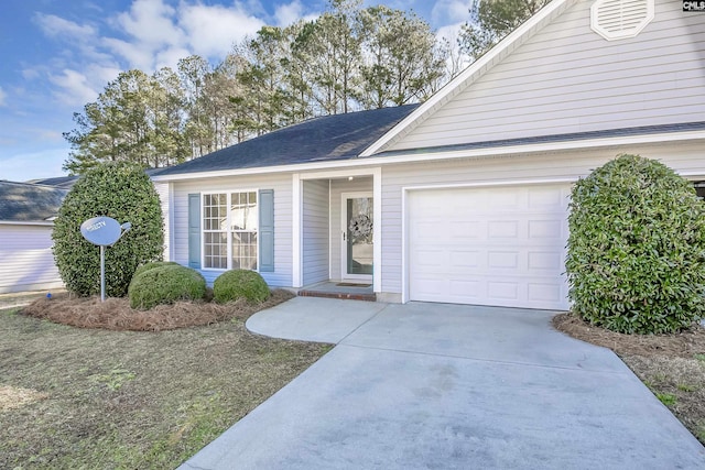 ranch-style house with a garage and driveway