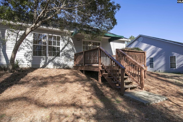 rear view of house with a deck and stairs