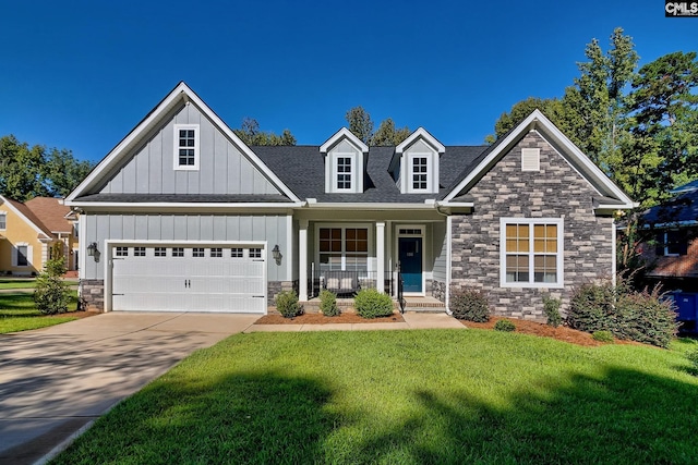 view of front of property featuring a shingled roof, concrete driveway, board and batten siding, stone siding, and a front lawn