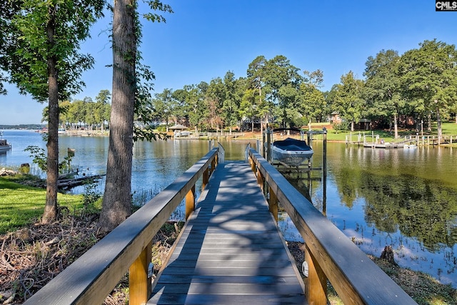 dock area with a water view and boat lift