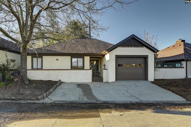 single story home with a fenced front yard, roof with shingles, stucco siding, concrete driveway, and an attached garage