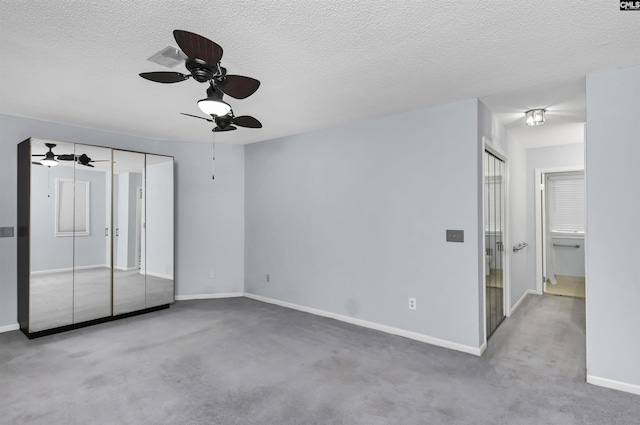 unfurnished bedroom featuring ceiling fan, baseboards, and a textured ceiling