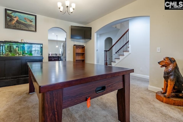 recreation room featuring arched walkways, baseboards, a chandelier, and light colored carpet