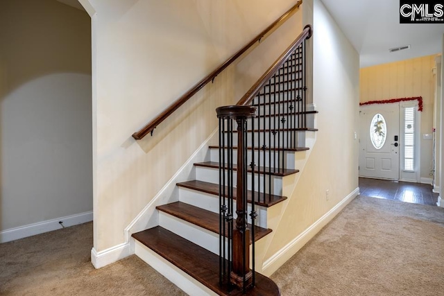 stairway with carpet, visible vents, and baseboards