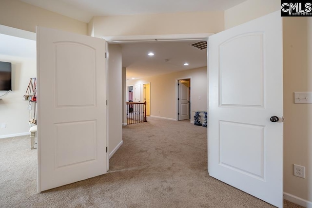 hall with carpet floors, recessed lighting, visible vents, and baseboards