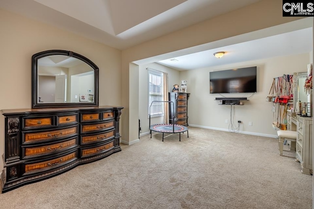 living area featuring baseboards and carpet flooring