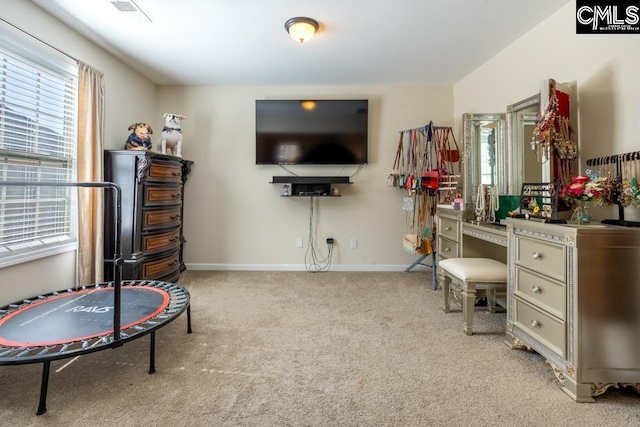 rec room with carpet, visible vents, and baseboards