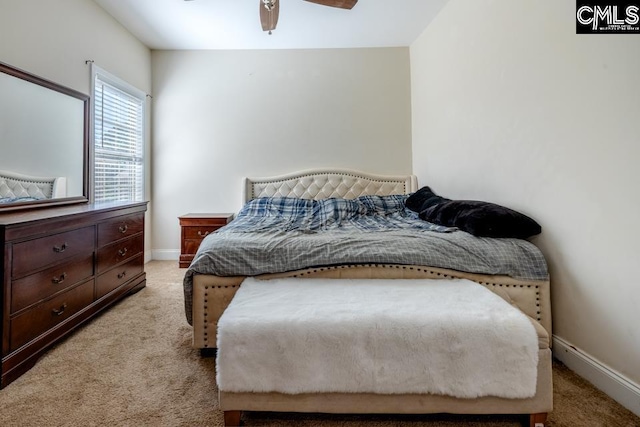 carpeted bedroom featuring ceiling fan and baseboards