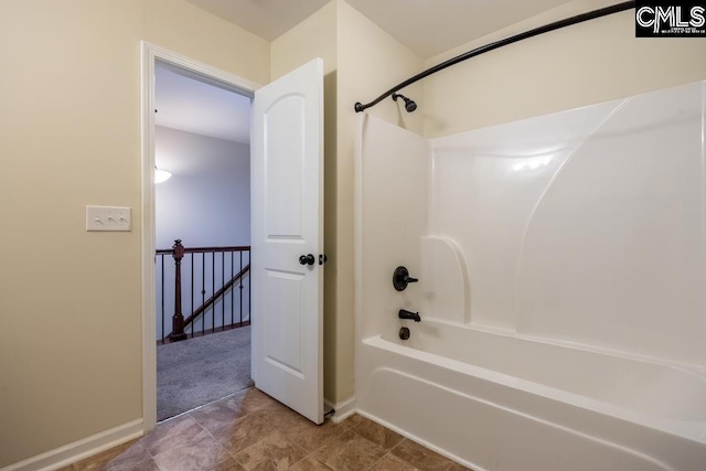 bathroom with  shower combination and baseboards