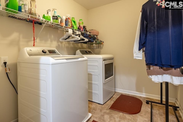 washroom featuring laundry area, independent washer and dryer, and baseboards