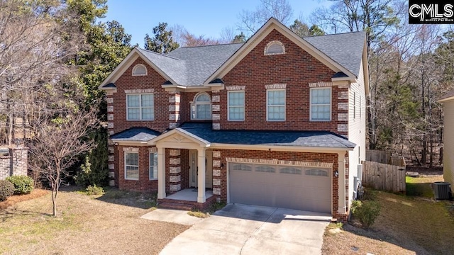 view of front of property with central air condition unit, brick siding, a shingled roof, fence, and driveway