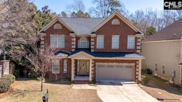 view of front of property featuring central air condition unit, driveway, an attached garage, and brick siding