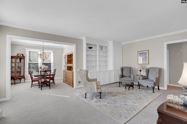 sitting room with carpet floors, built in shelves, a notable chandelier, ornamental molding, and baseboards