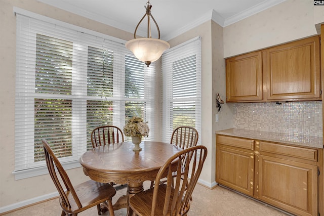 dining space featuring baseboards and ornamental molding