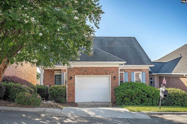 view of front of property featuring a garage, concrete driveway, and brick siding