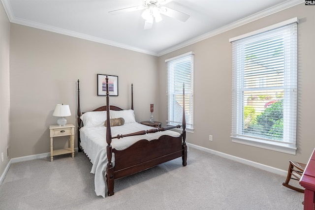 bedroom with ornamental molding, light colored carpet, baseboards, and a ceiling fan