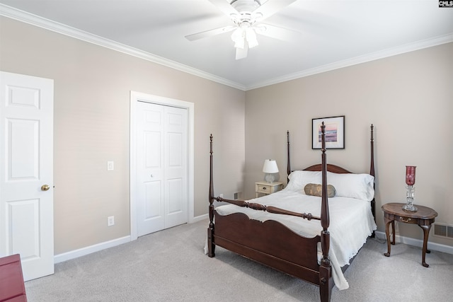 bedroom with baseboards, ornamental molding, a closet, and light colored carpet