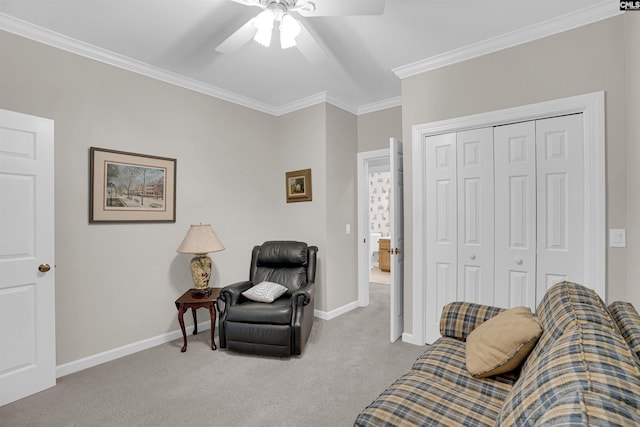 sitting room with carpet floors, baseboards, a ceiling fan, and ornamental molding