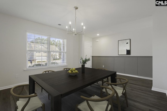 dining area with an inviting chandelier, baseboards, visible vents, and dark wood finished floors