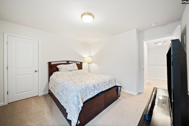 carpeted bedroom featuring visible vents and baseboards