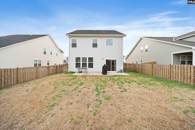 back of house featuring a fenced backyard, a lawn, and a patio