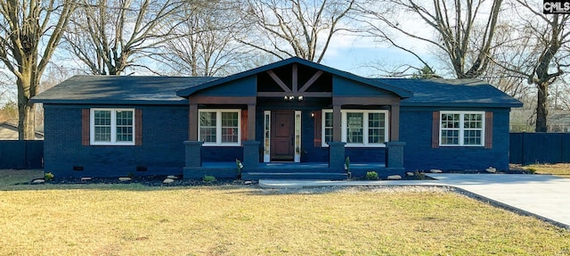 view of front of house featuring a porch, brick siding, fence, crawl space, and a front lawn