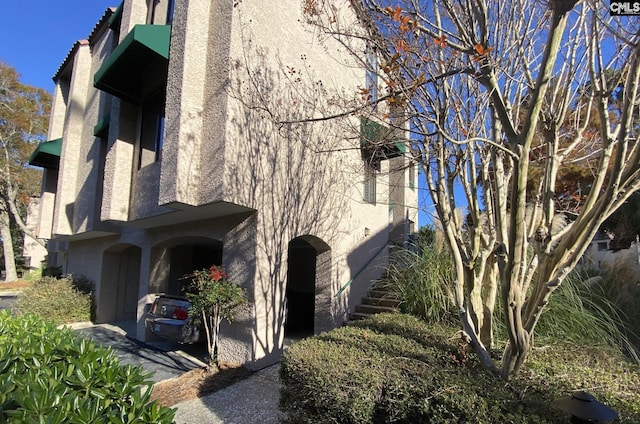 view of side of home with stucco siding