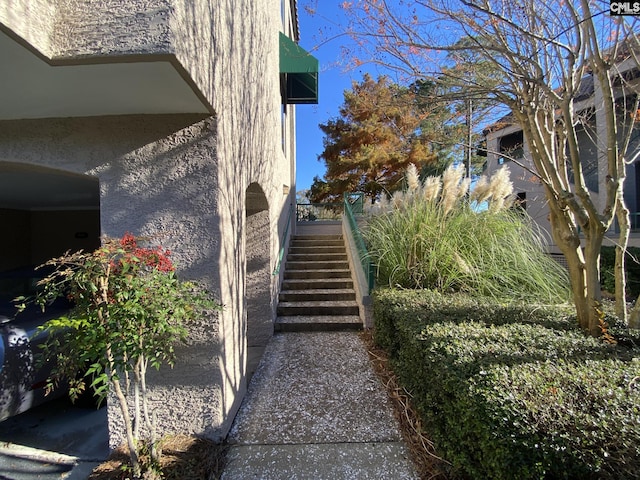 view of side of home featuring stairs