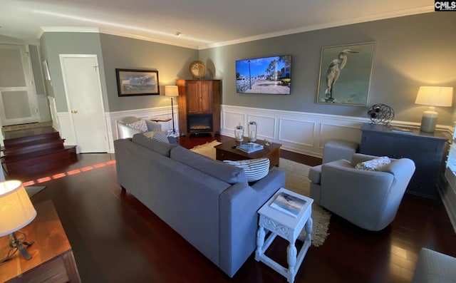 living area featuring a wainscoted wall, crown molding, a fireplace, stairway, and wood finished floors