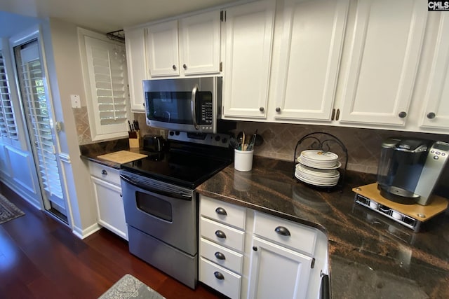 kitchen with stainless steel appliances, white cabinetry, and tasteful backsplash