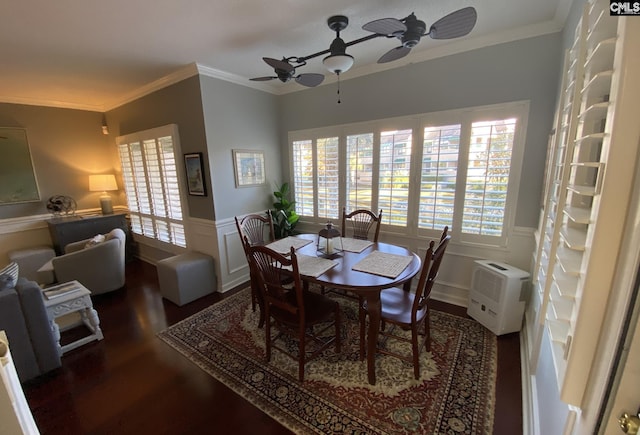 dining room featuring a ceiling fan, wainscoting, ornamental molding, wood finished floors, and a wall mounted air conditioner