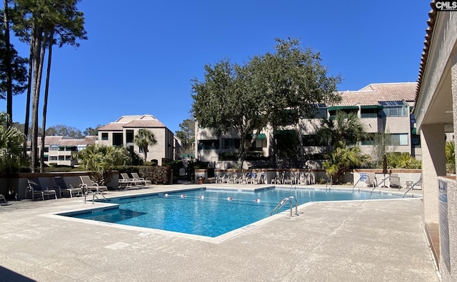 community pool featuring a patio area and fence