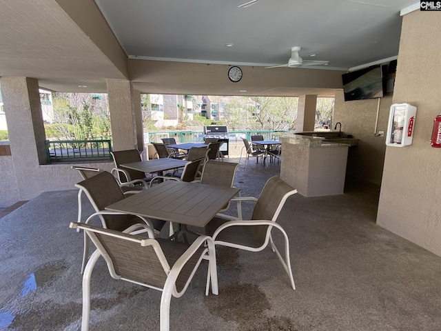 view of patio featuring outdoor dining space, grilling area, and a ceiling fan