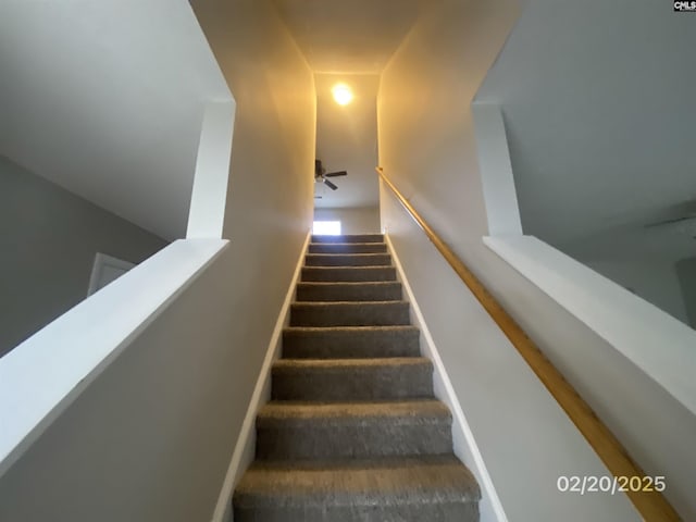 staircase with a ceiling fan