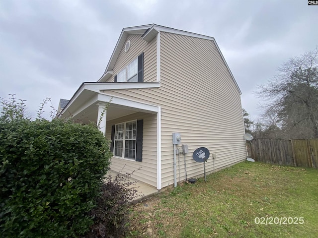 view of home's exterior featuring fence and a yard