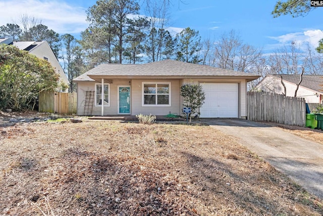 ranch-style home with an attached garage, driveway, and fence