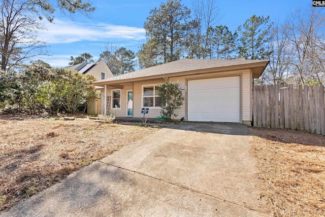 single story home featuring a garage, driveway, and fence