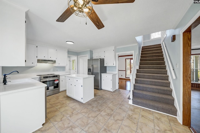 kitchen with under cabinet range hood, stainless steel appliances, a sink, white cabinets, and light countertops