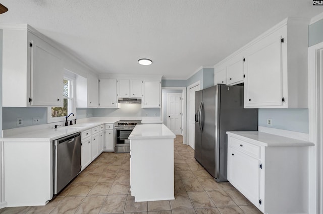 kitchen with under cabinet range hood, white cabinetry, stainless steel appliances, and a sink